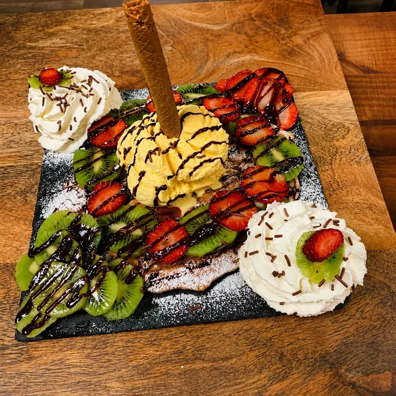 Gaufre garnie de fruits, glace vanille et cornet, chocolat et chantilly